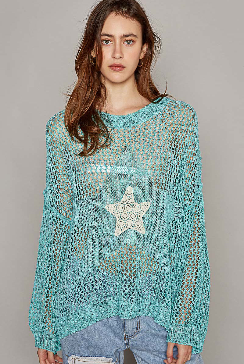 Oversized crochet star sweater by RARA Boutique featuring a cozy knit design and bold star pattern in soft colors.
