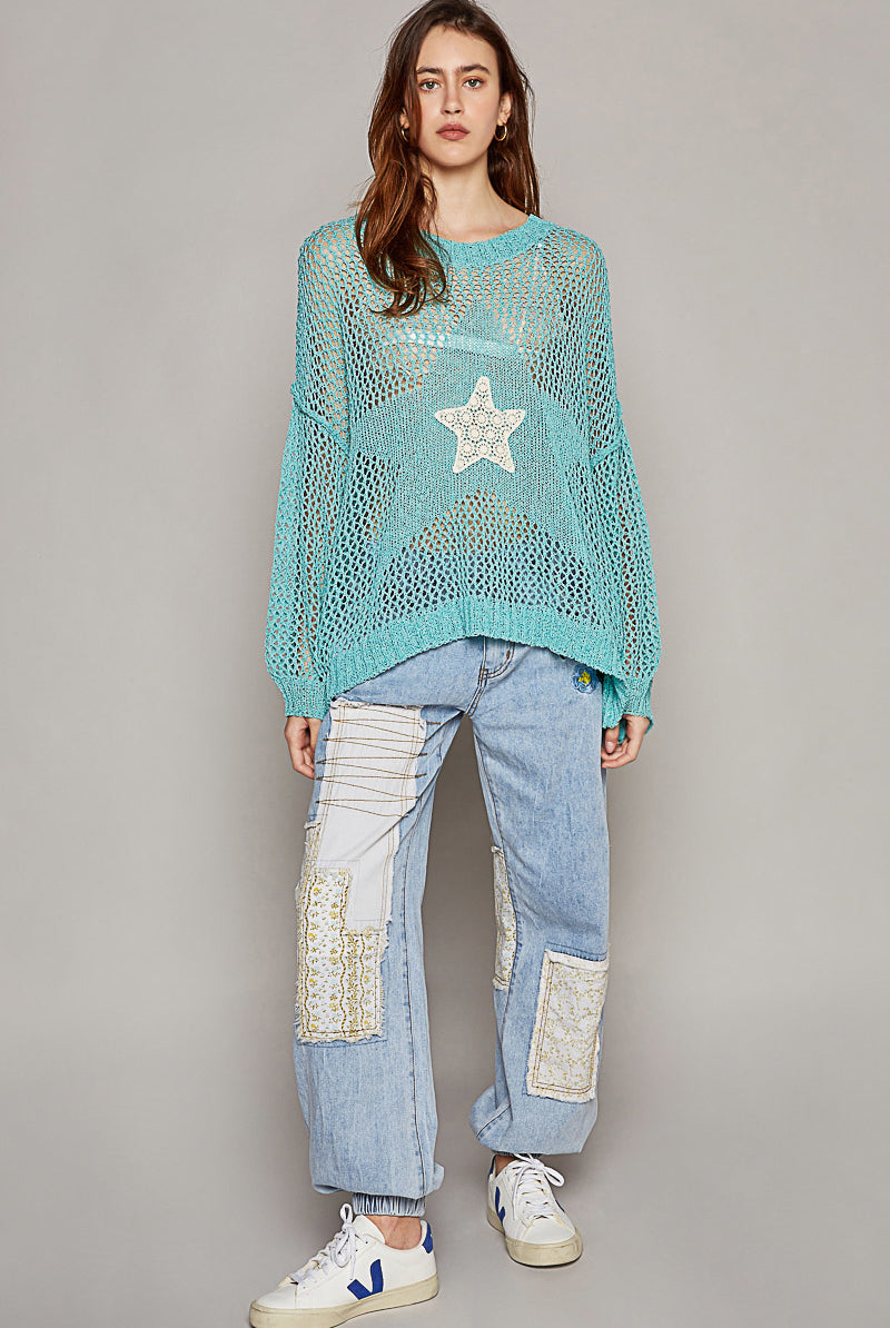 Oversized crochet star sweater by RARA Boutique featuring a cozy, chunky knit design with star patterns on a soft fabric.
