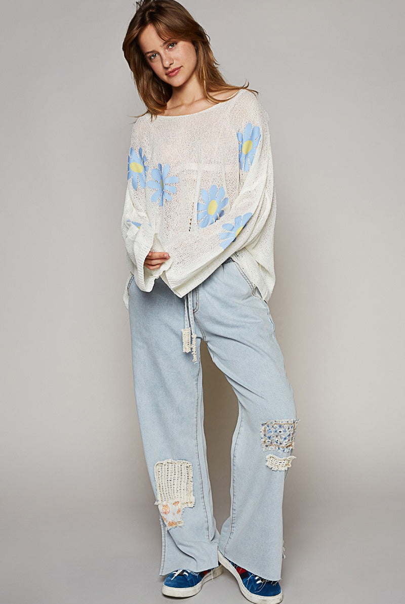 RARA Boutique long sleeve distressed flower print knit sweater with floral design and textured knit fabric.