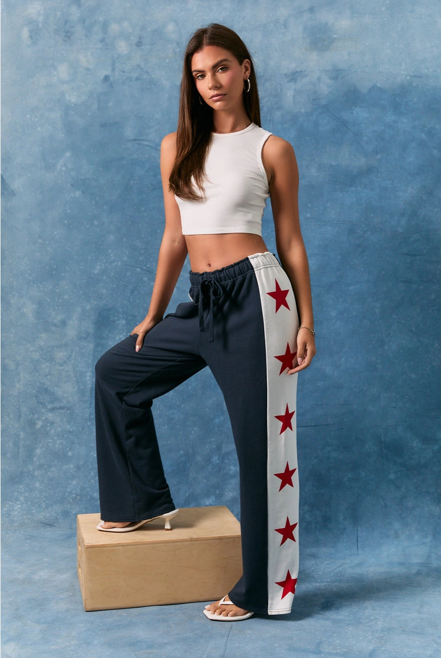 Le Lis Star Side Stripe Wide Leg Baggy Sweatpants from RARA Boutique, showing the relaxed fit and star side stripe design.