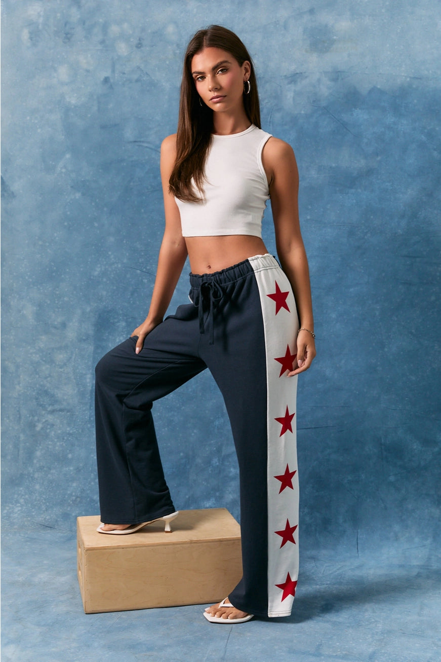 Le Lis Star Side Stripe Wide Leg Baggy Sweatpants from RARA Boutique, showing the relaxed fit and star side stripe design.