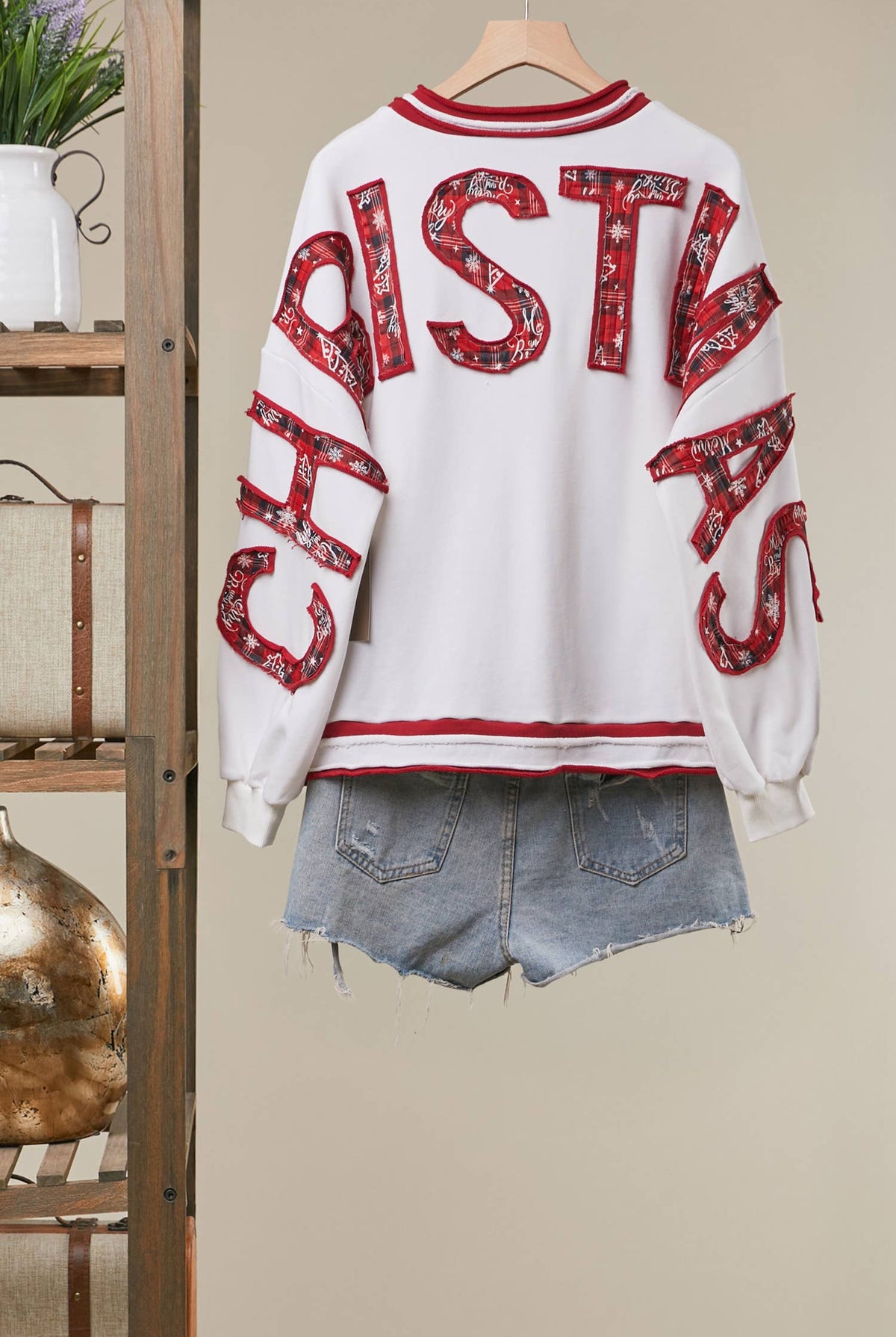 Mello Tuesday Holiday Merry Christmas letter sweatshirt featuring festive red and white design with holiday-themed lettering.