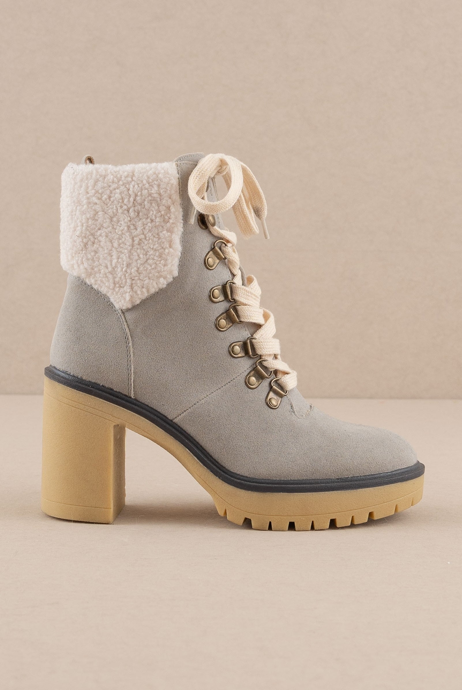 RARA Boutique heeled platform lace-up sherpa boots with chunky sole and cozy fur lining, stylish ankle-length boot for winter wear.