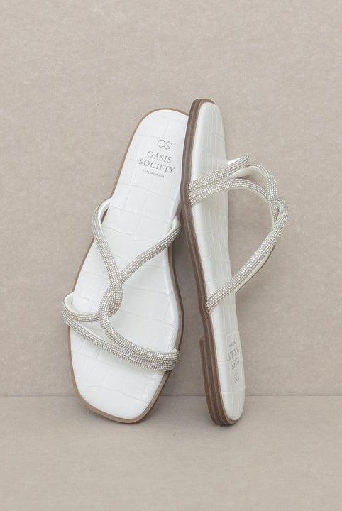 RARA Boutique strappy rhinestone sandals with open toe and heel, featuring sparkling embellishments and delicate ankle straps.