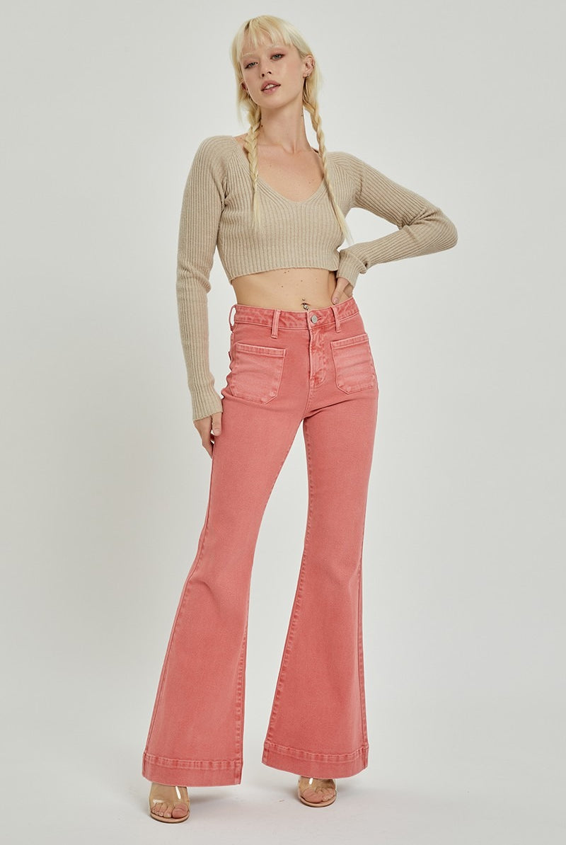 Risen high rise patch pocket bell bottom jeans with distressed details and flared legs, styled with casual top and accessories.
