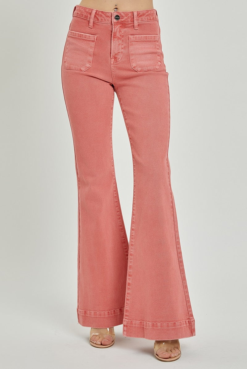 Risen high rise patch pocket bell bottom jeans with flared legs and classic denim wash, styled on a model.