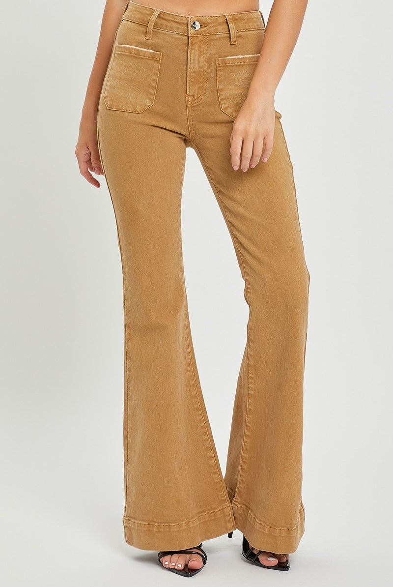Risen high rise patch pocket bell bottom jeans with distressed details and flared legs, styled with casual top and accessories.