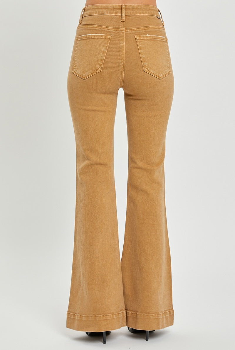 Risen high rise patch pocket bell bottom jeans in denim, featuring flared legs and classic stitch details, shown on a model.