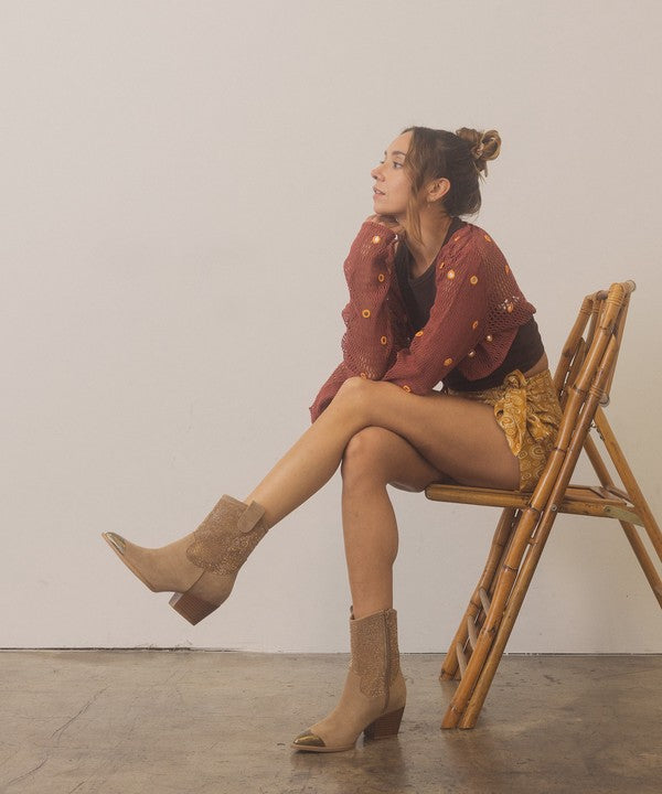 Rhinestone studded western booties with metal toe from RARA Boutique, featuring a stylish design and pointed toe detail.