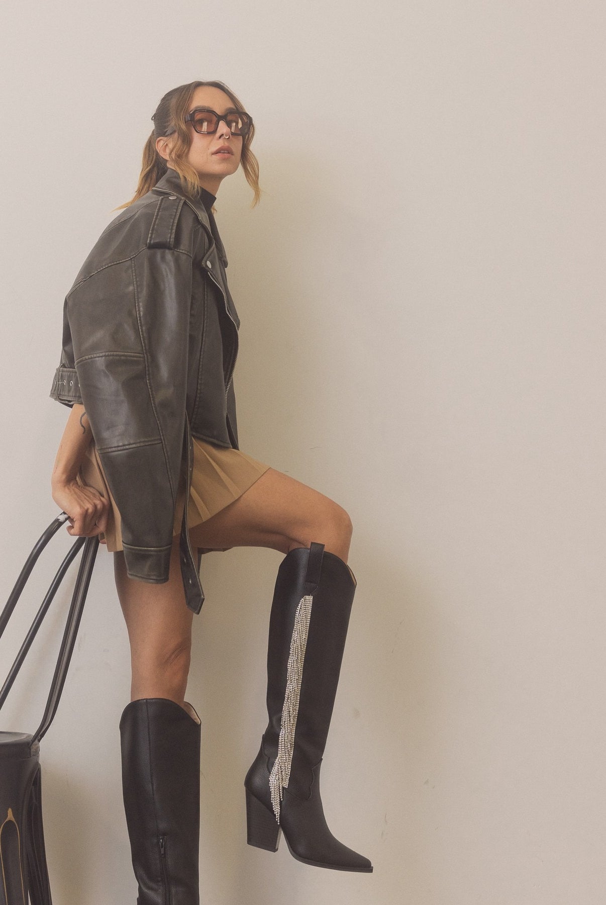 Rara Boutique rhinestone fringe knee-high Western boots with intricate detailing and Western style, perfect for stylish outfits.