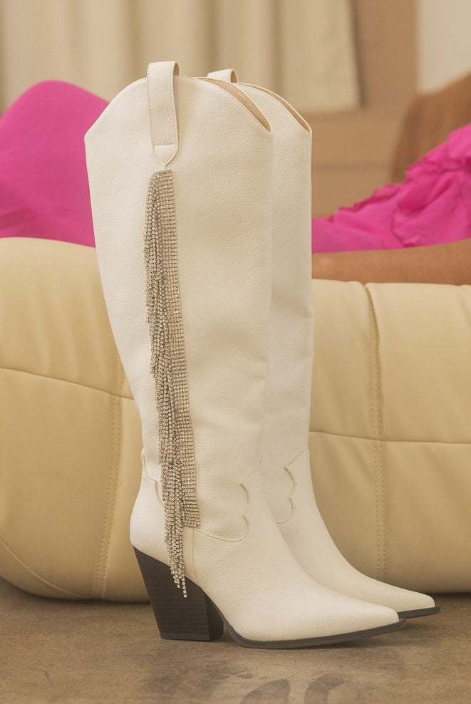 Rhinestone fringe knee-high Western boots by RARA Boutique featuring sparkling rhinestones and Western-style design.