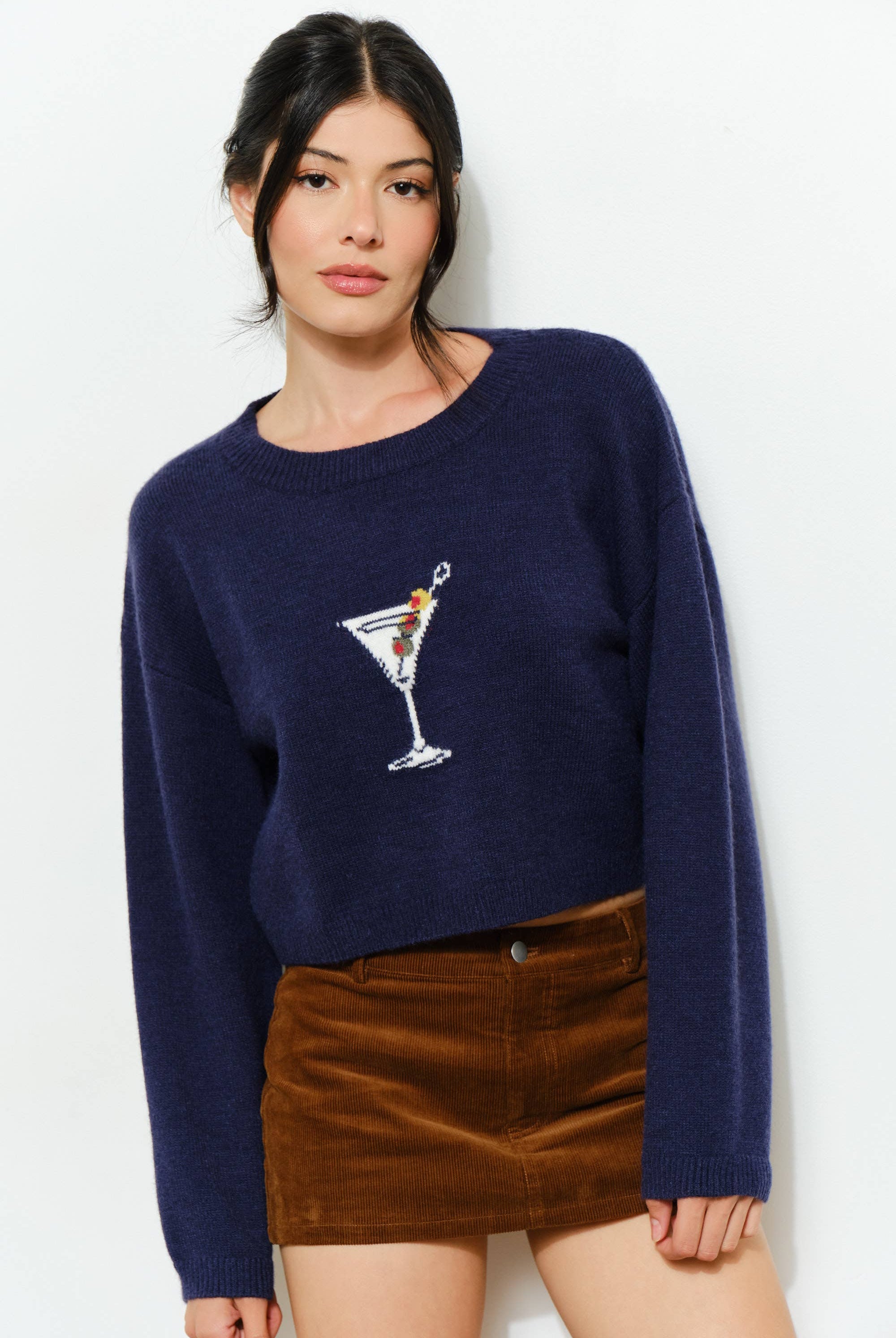 Pretty Garbage KAINA Martini Sweater displayed on a hanger, featuring a cozy knit fabric and a stylish, relaxed fit.