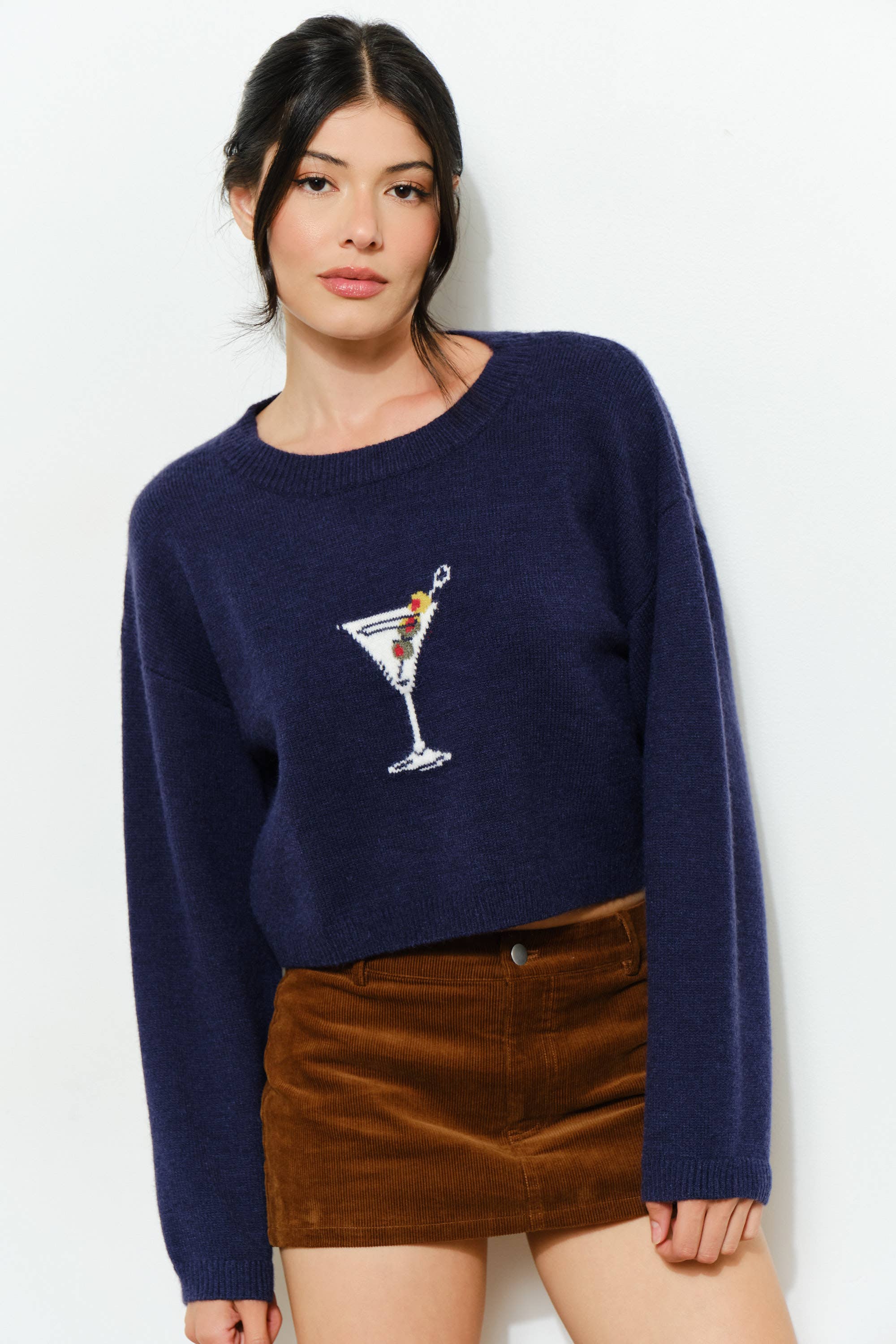 Pretty Garbage KAINA Martini Sweater displayed on a hanger, featuring a cozy knit fabric and a stylish, relaxed fit.