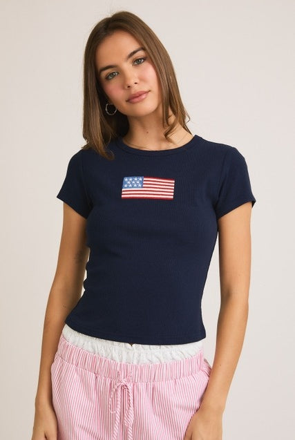 Ribbed baby tee by RARA Boutique featuring embroidered American flag design, soft cotton fabric, and short sleeves.