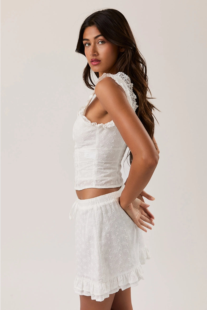 RARA Boutique sleeveless blouse with eyelet lace trim and square neckline, featuring a stylish, feminine design.