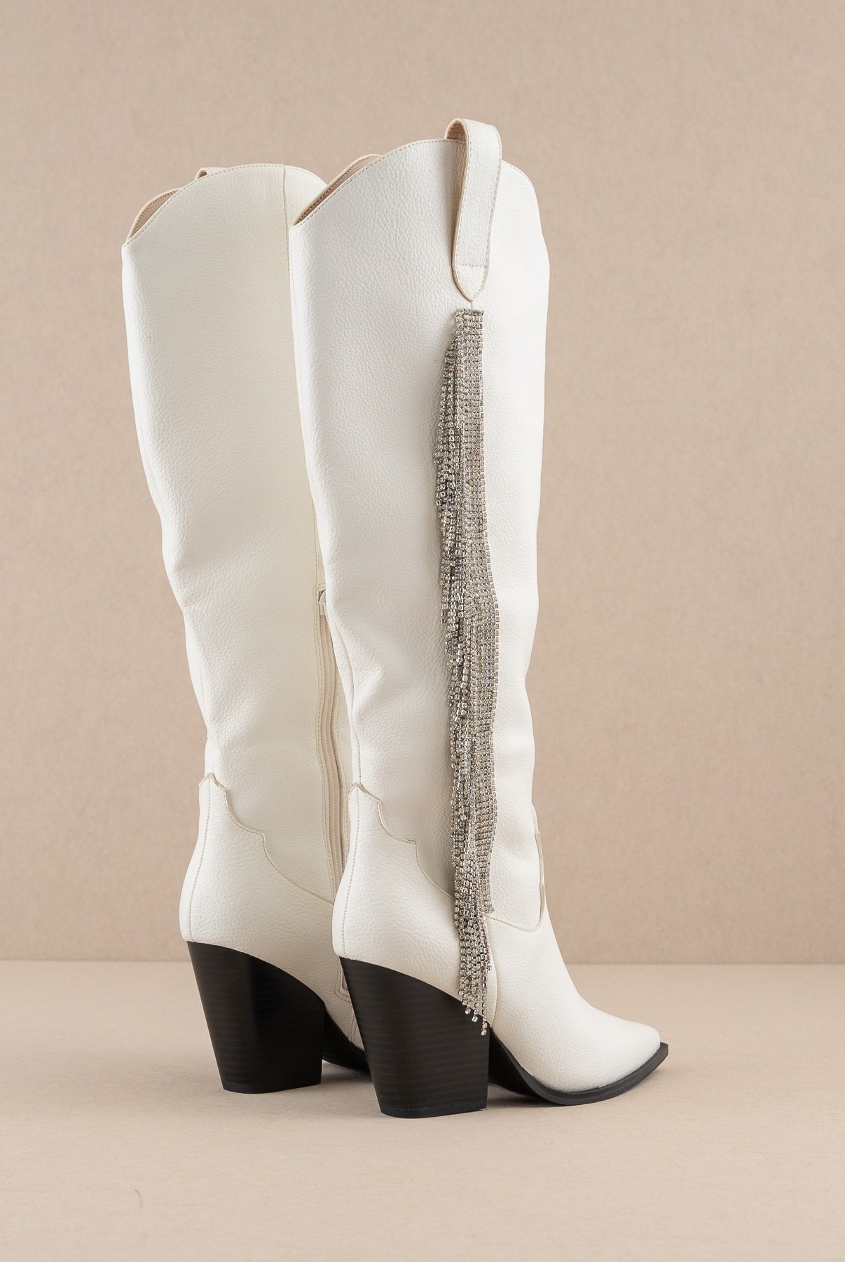 Rhinestone fringe knee-high Western boots from RARA Boutique with intricate western stitching and sparkling rhinestone details.