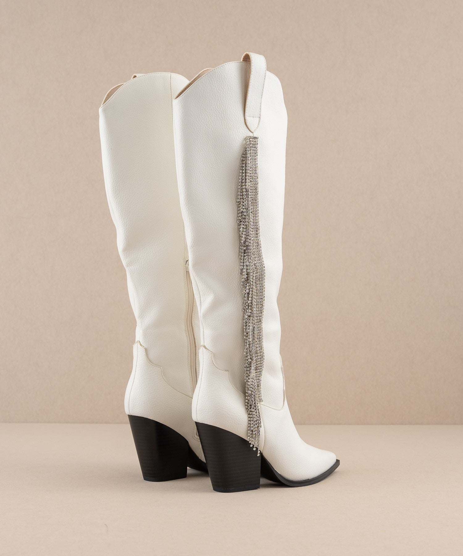 Rhinestone fringe knee-high Western boots from RARA Boutique with intricate western stitching and sparkling rhinestone details.