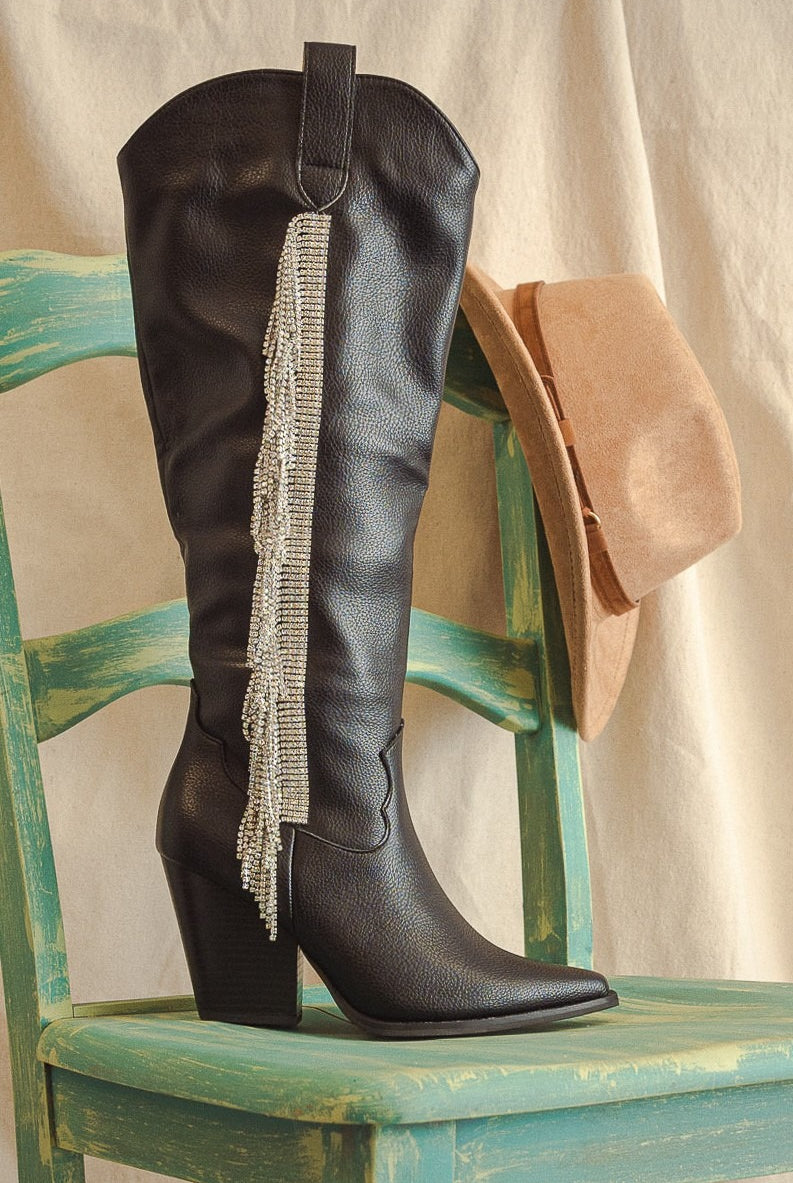 Rara Boutique rhinestone fringe knee-high western boots with decorative embellishments and intricate stitching.