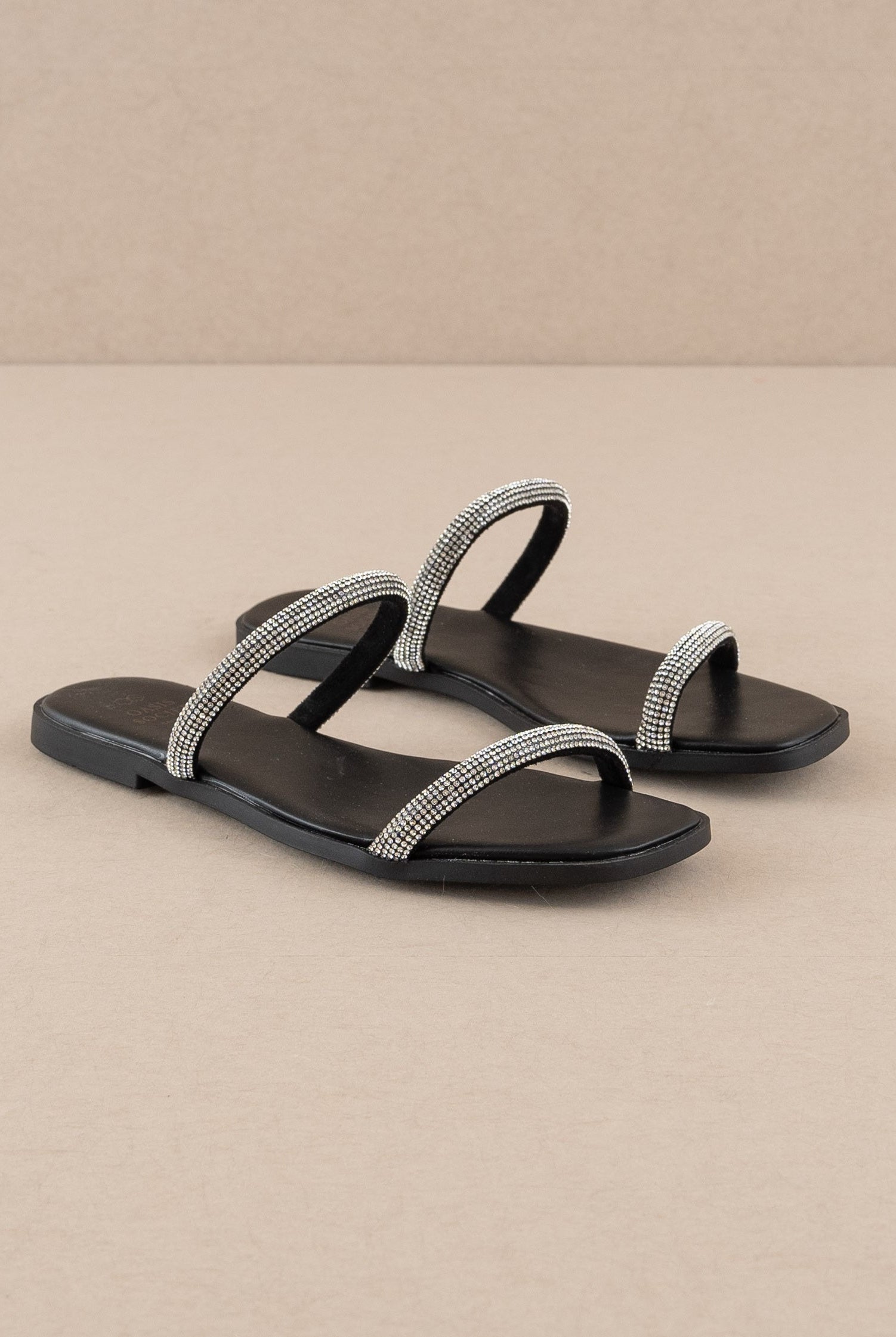 Rhinestone strappy flat slide sandals by RARA Boutique featuring sparkling rhinestones and a minimalist design.