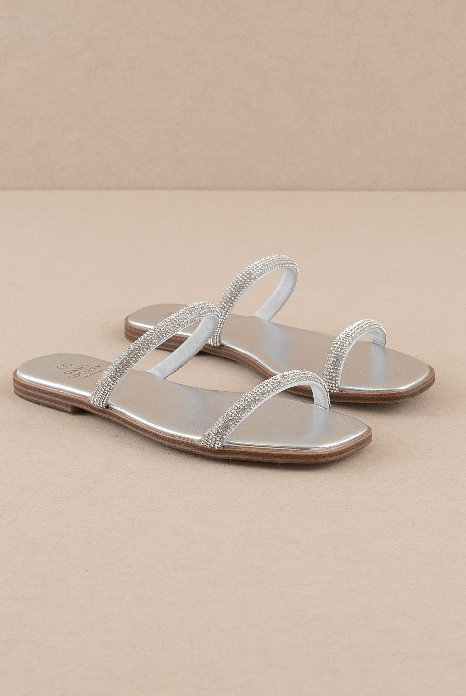 Rhinestone strappy flat slide sandals by RARA Boutique with sparkling embellishments and multiple thin straps on a flat sole.