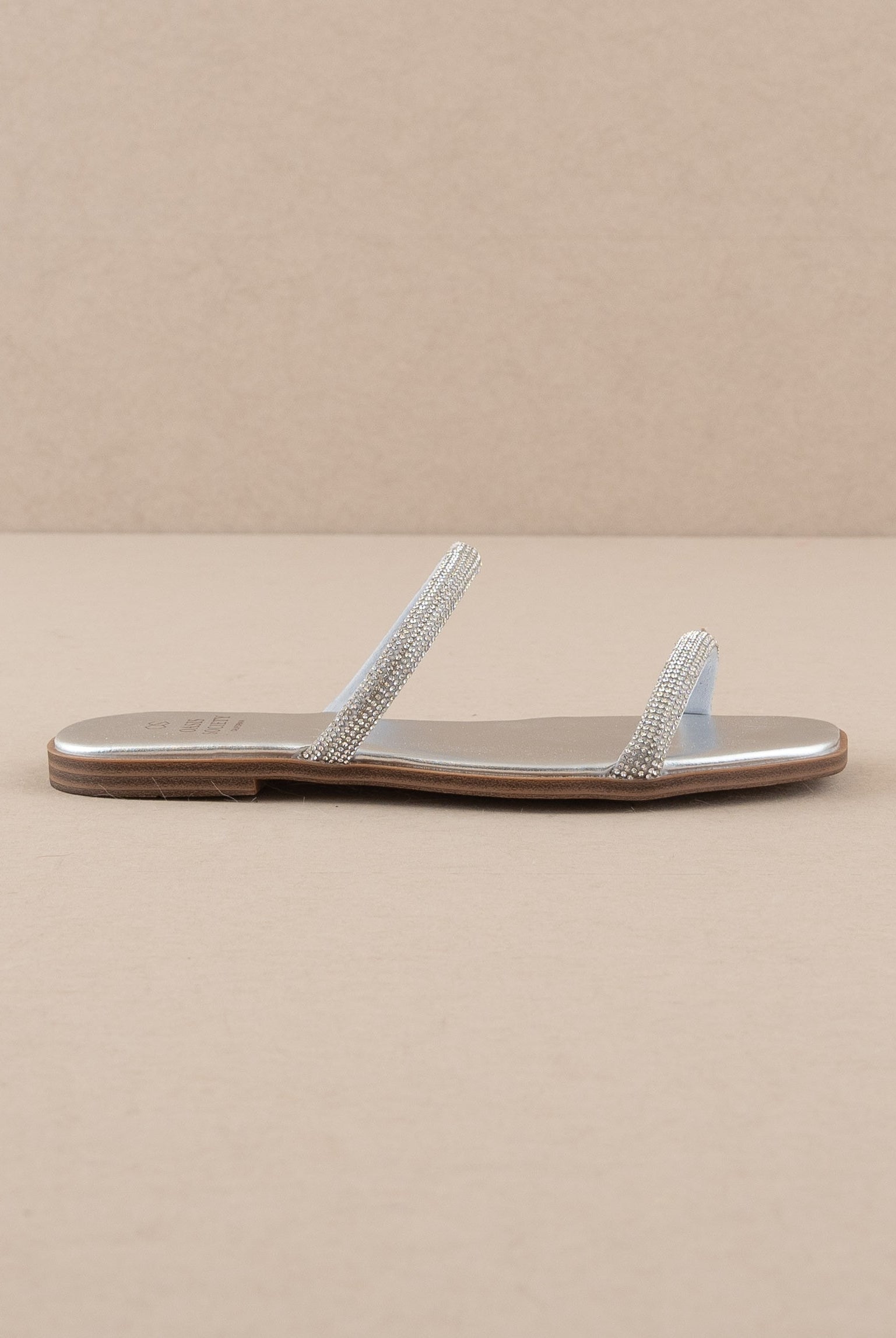 Rhinestone strappy flat slide sandals by RARA Boutique featuring sparkling rhinestones and a comfortable flat sole.