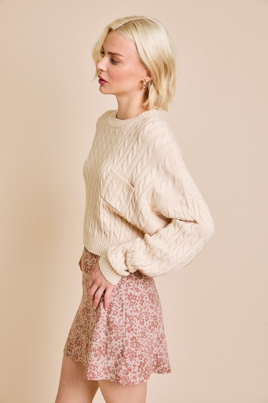 RARA Boutique Dolman sleeve cable knit cropped sweater with front pocket, soft and cozy for casual wear.