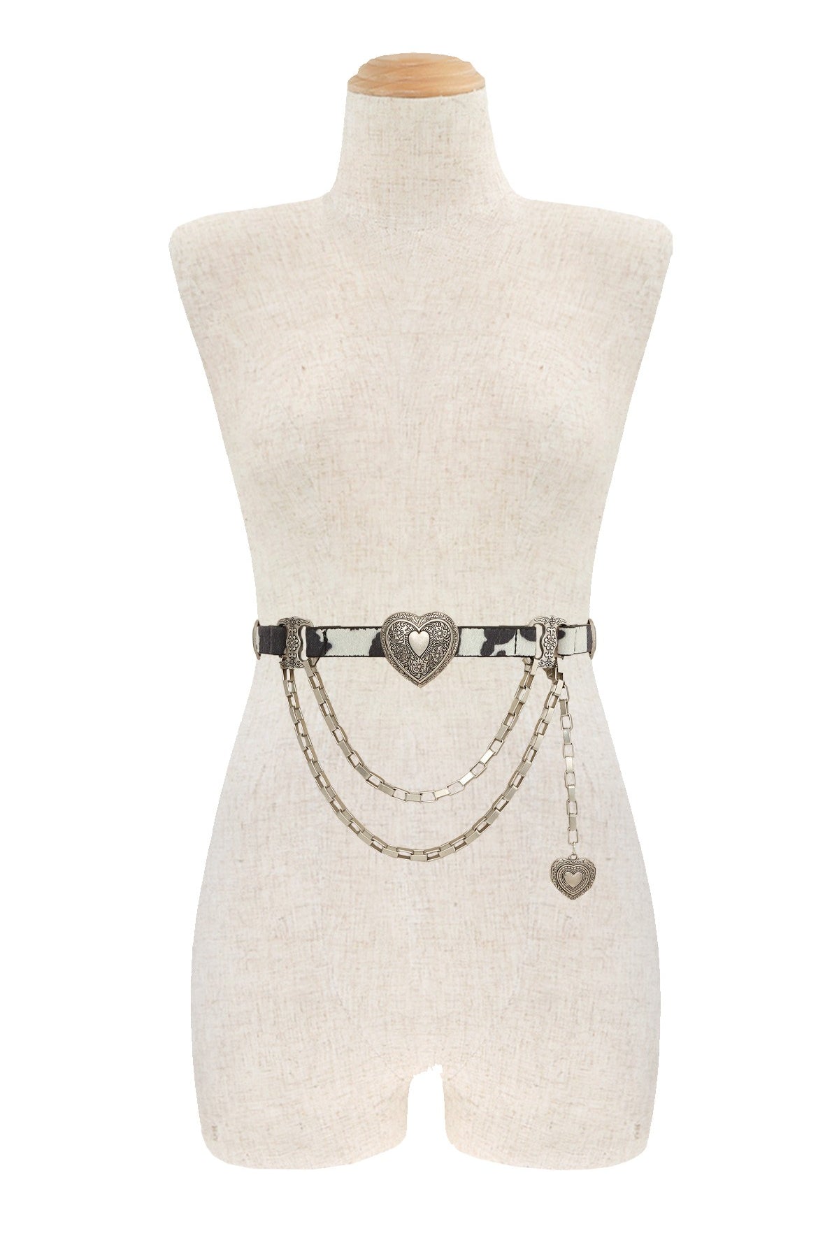 Western cowhide chain belt with engraved heart concho from RARA Boutique, showcasing detailed metal accents and genuine leather.