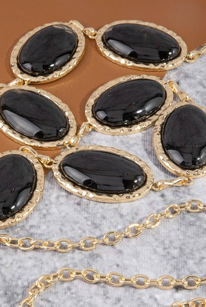 Oval stone gold frame chain belt with elegant design, featuring oval stones and a gold chain for stylish waist accessory.