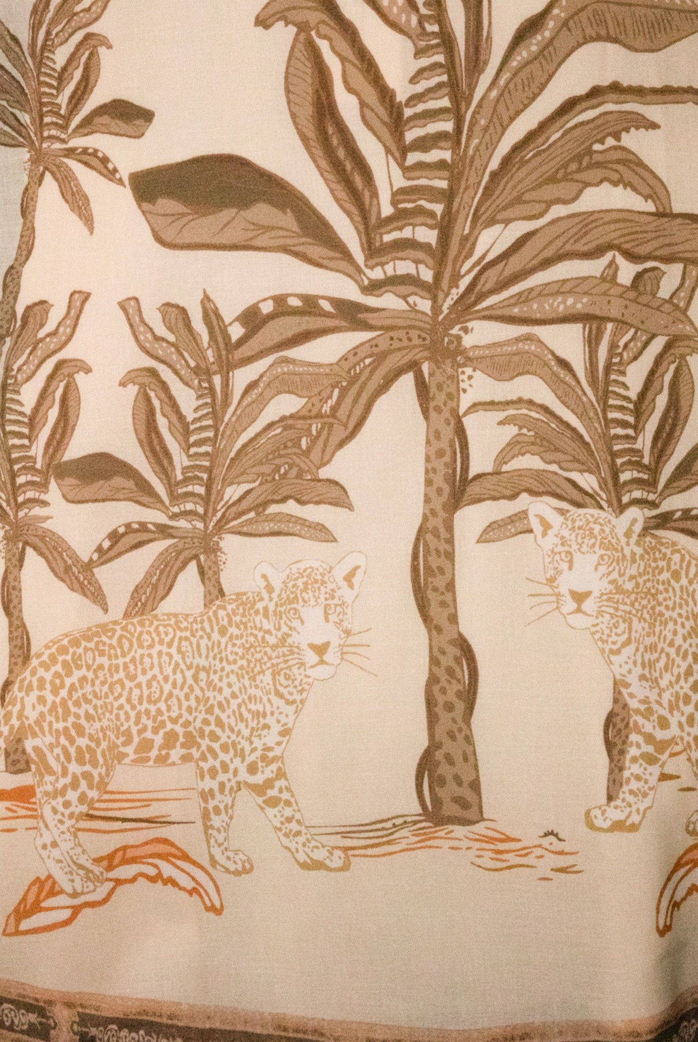 Tropical palm and leopard print maxi skirt by RARA Boutique in peach, flowing fabric with vibrant pattern details.