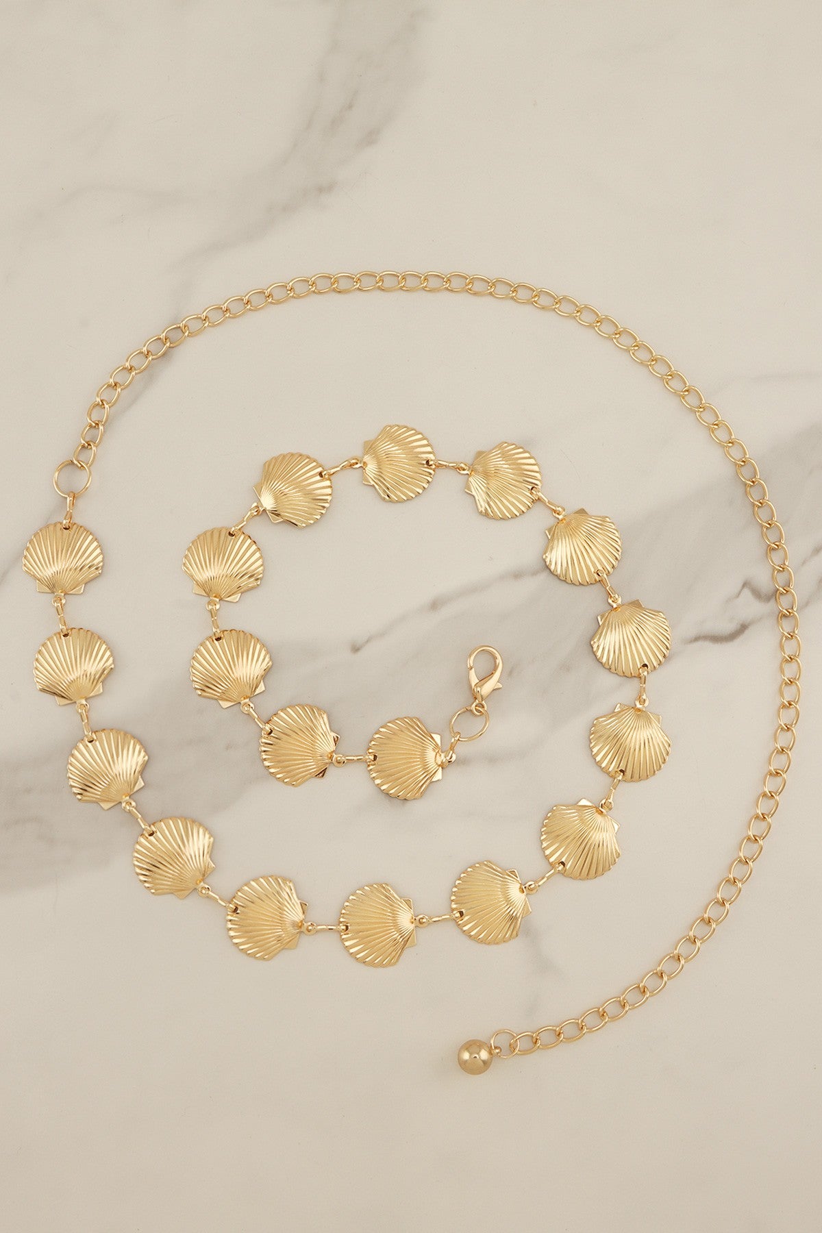 RARA Boutique scallop seashell textured link chain belt with intricate shell design and metallic finish.