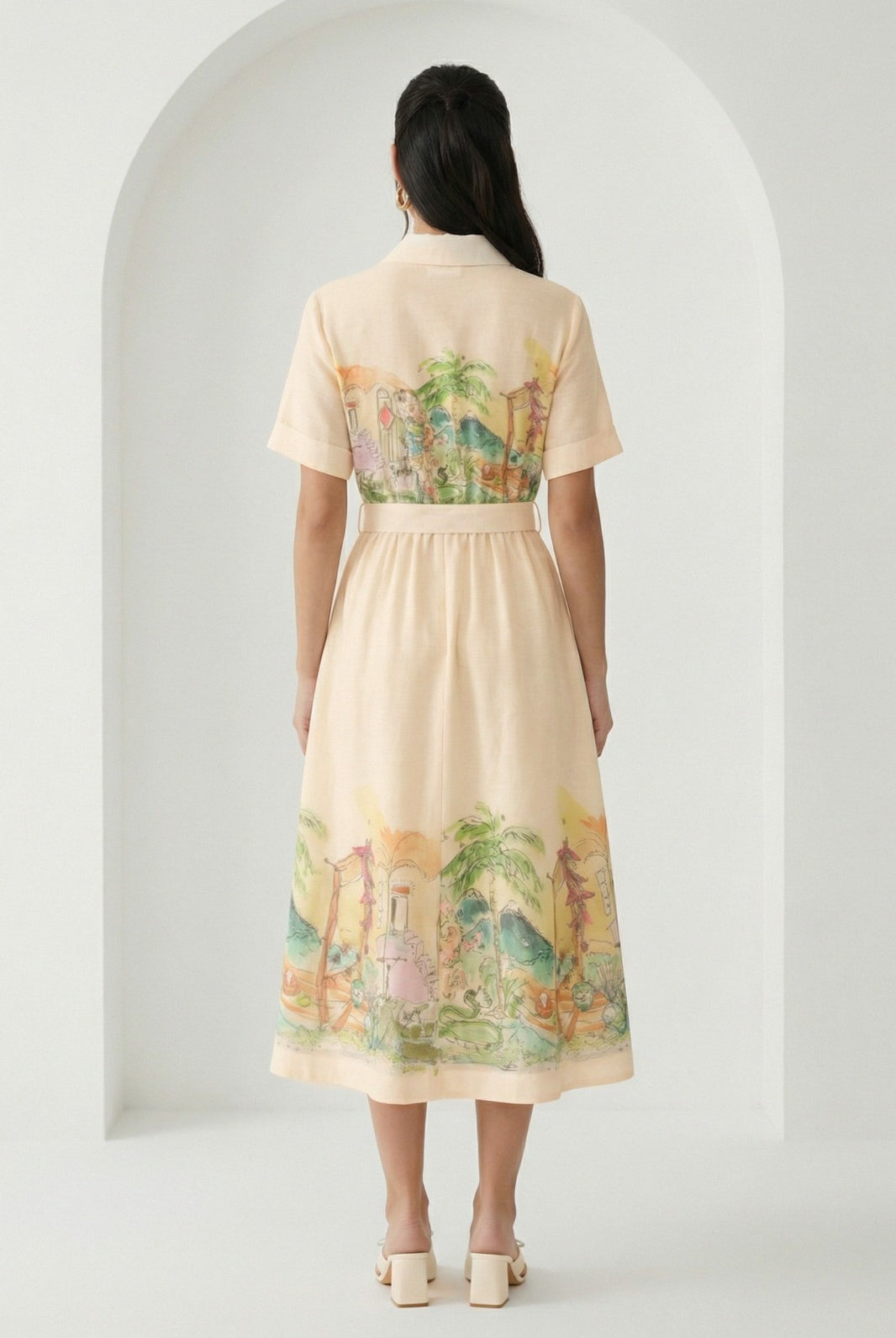 Watercolor village print belted midi dress from RARA Boutique featuring a peach-colored floral design and relaxed fit.