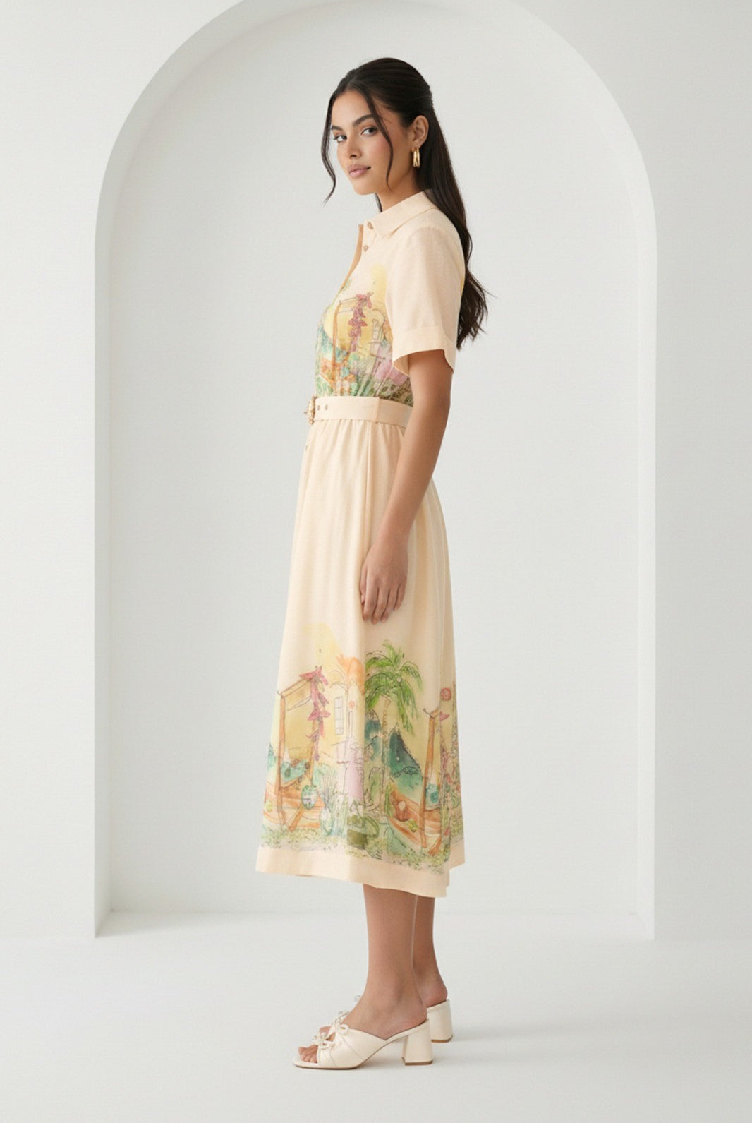 Watercolor village print belted midi dress by RARA Boutique in peach, featuring a flowy design and watercolor landscape pattern.
