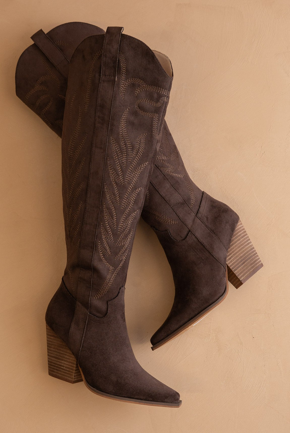 Tall knee-high western embroidered pointed toe boots by RARA Boutique featuring intricate embroidery and a stylish western design.