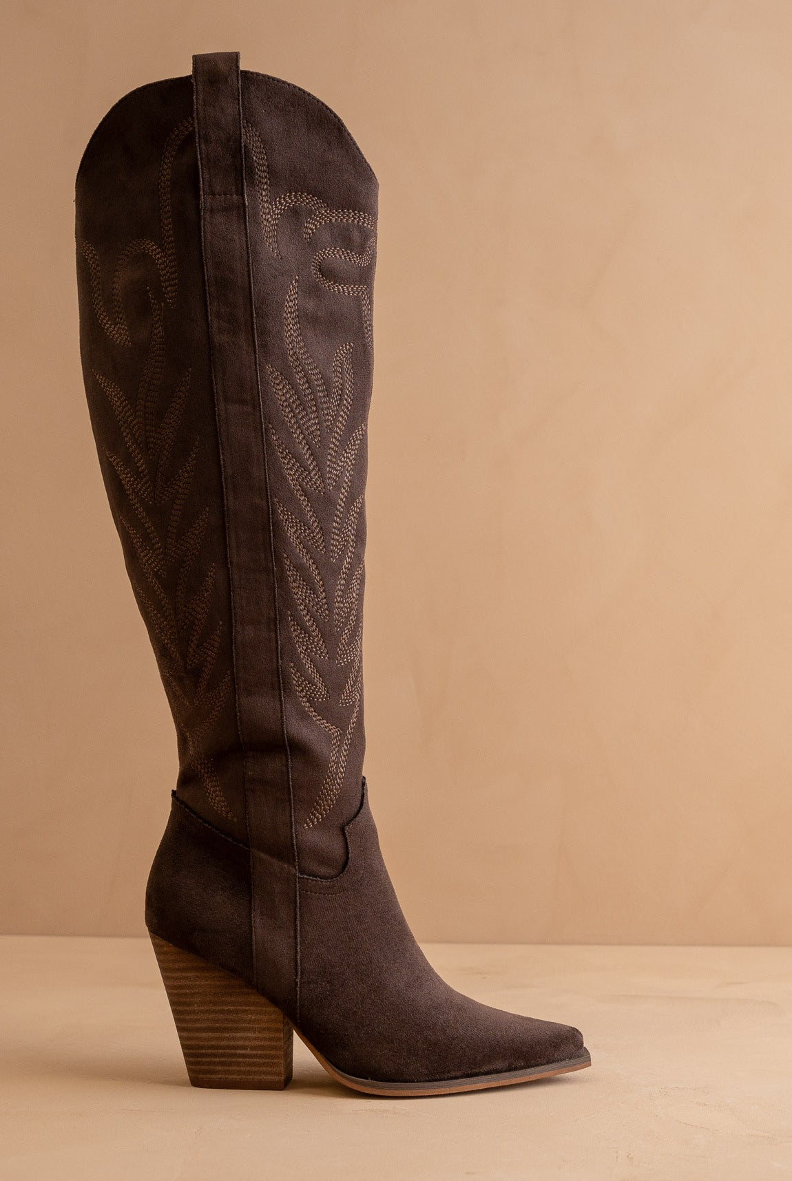 Tall knee-high Western embroidered pointed toe boots by RARA Boutique featuring intricate embroidery and Western style details.