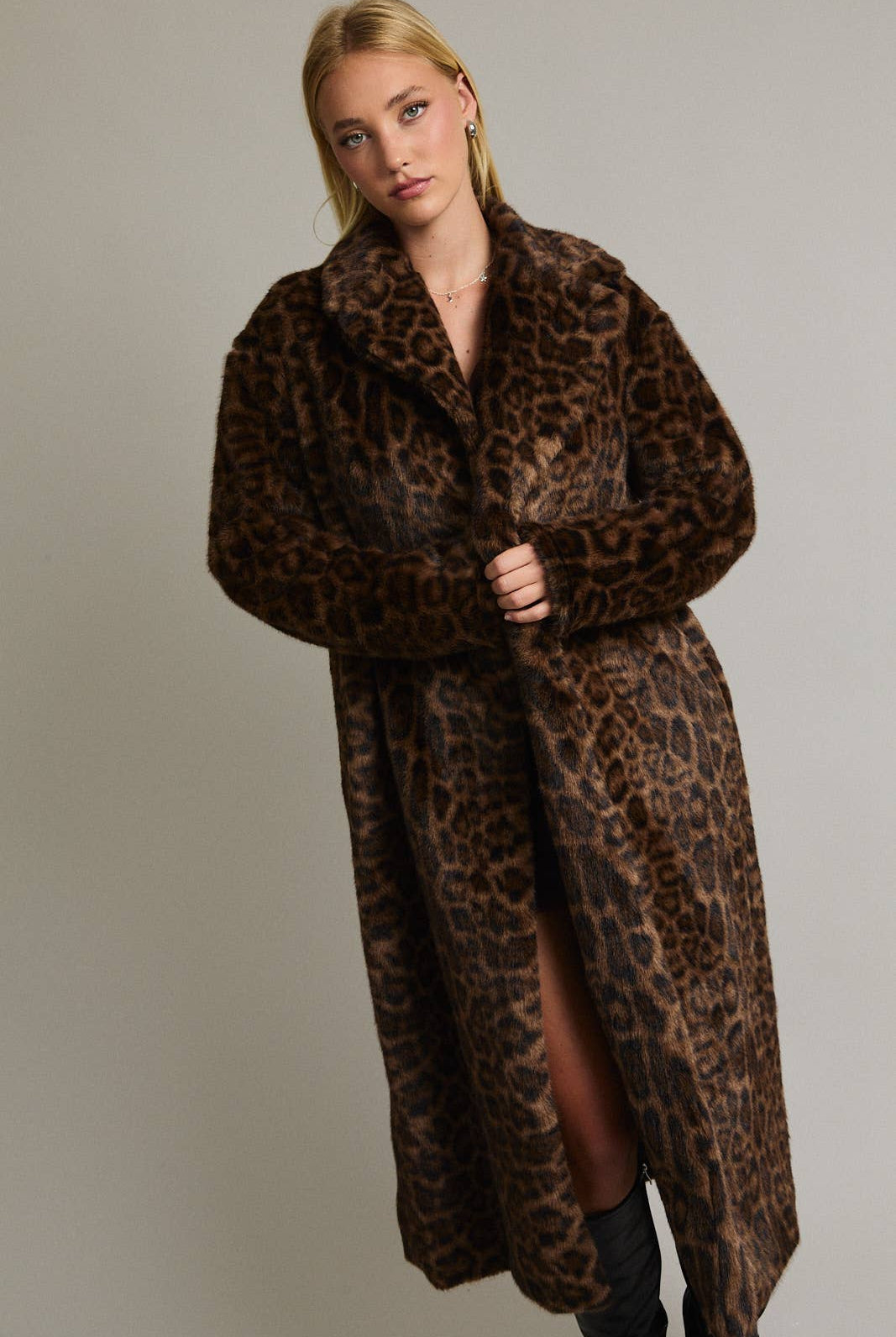 Le Lis faux fur long coat jacket displayed on a hanger, showcasing plush texture and luxurious design.