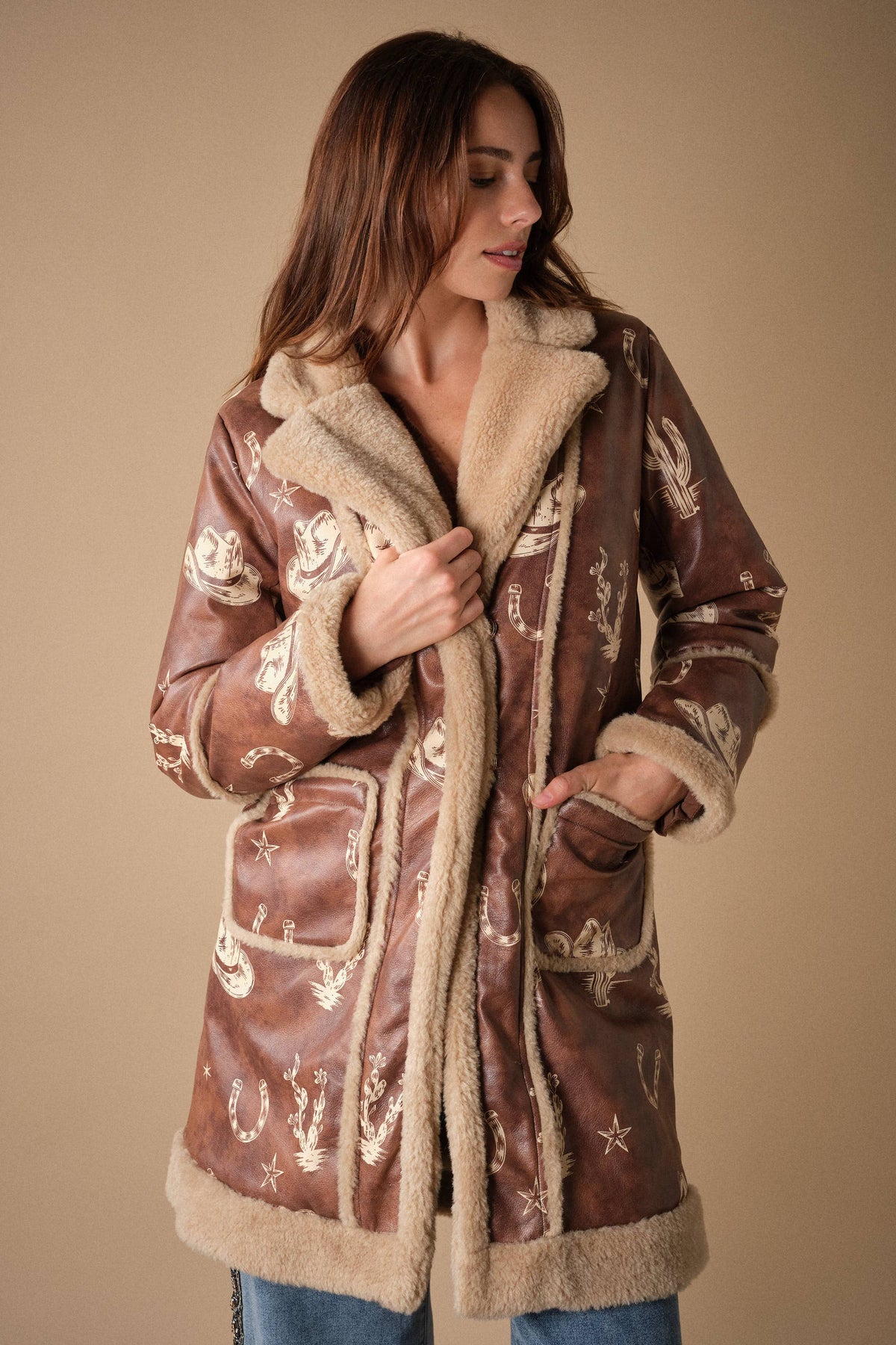 Blue B Western printed faux leather coat with intricate Western-style design and bold pattern, featuring a stylish collar and long sleeves.