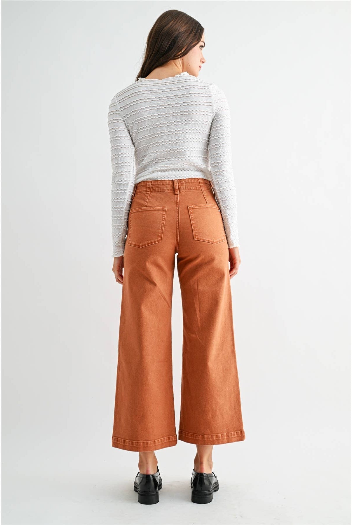 High-rise wide crop patch pocket jeans by Mica Denim, featuring distressed details and classic denim texture.