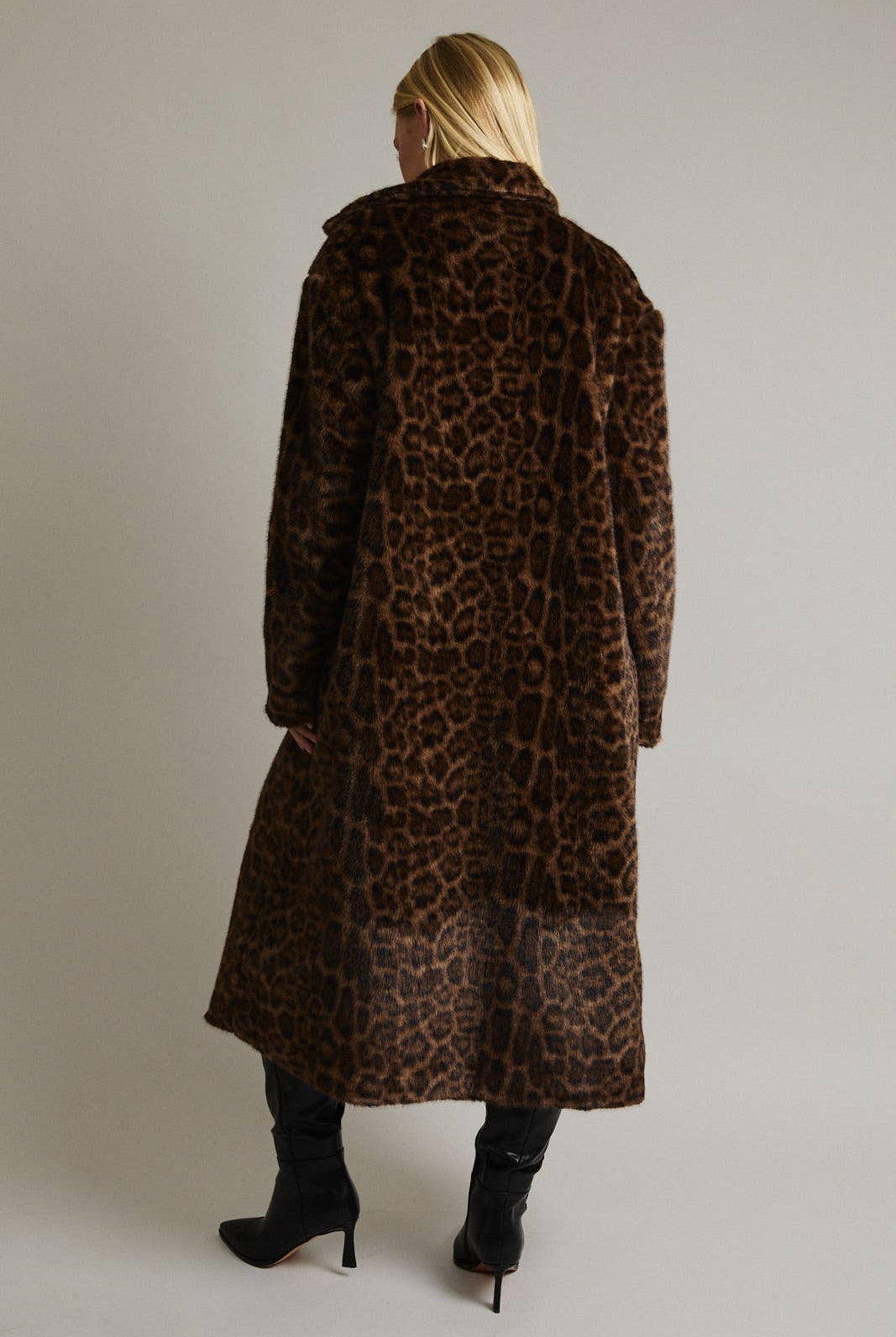 Le Lis faux fur long coat jacket with plush texture and collar, stylish winter outerwear displayed on a hanger.