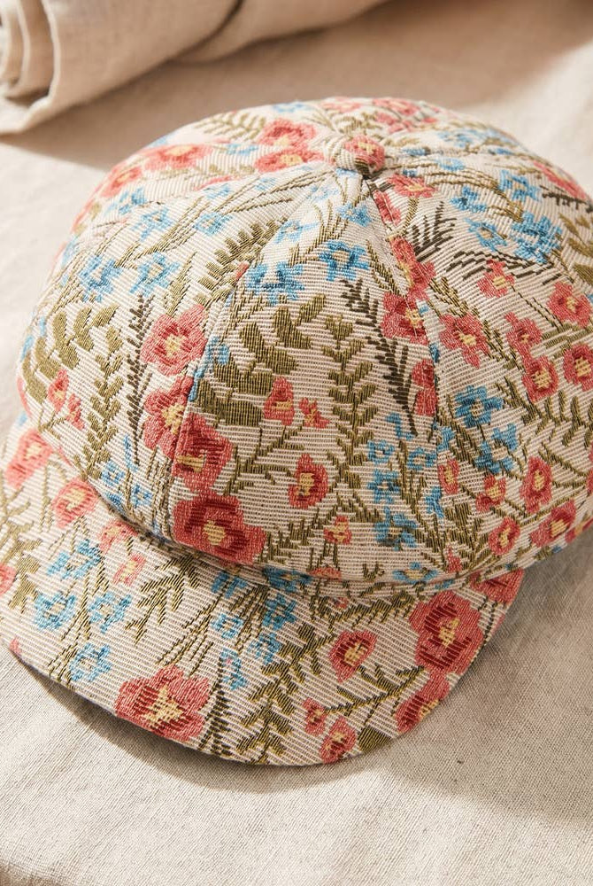Floral tapestry newsboy cabbie hat by Collections by Fame Accessories, featuring colorful floral fabric and classic newsboy style.