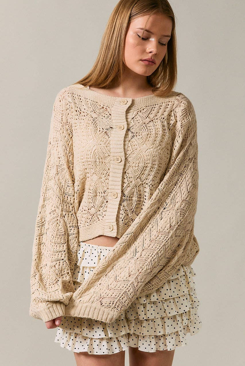 Long sleeve crochet cardigan by LE LIS featuring intricate knit pattern and lightweight fabric, displayed on a neutral background.