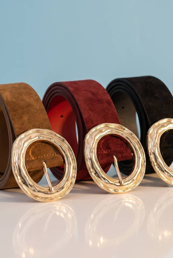 Suede hammered round buckle belt by Collections by Fame Accessories, featuring a textured leather strap and metal buckle detail.