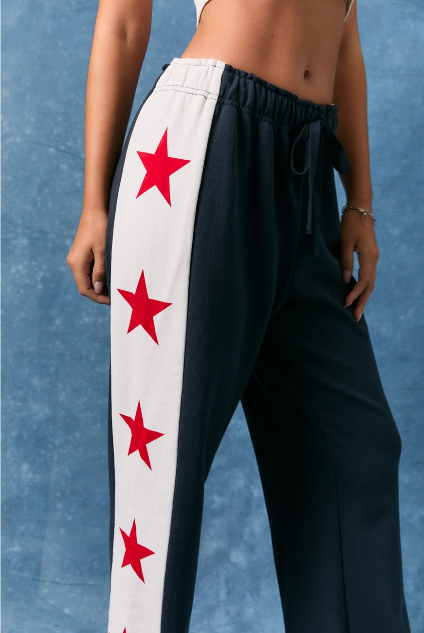 Le Lis star side stripe wide leg baggy sweatpants with relaxed fit and bold star accents, casual and comfortable for everyday wear.