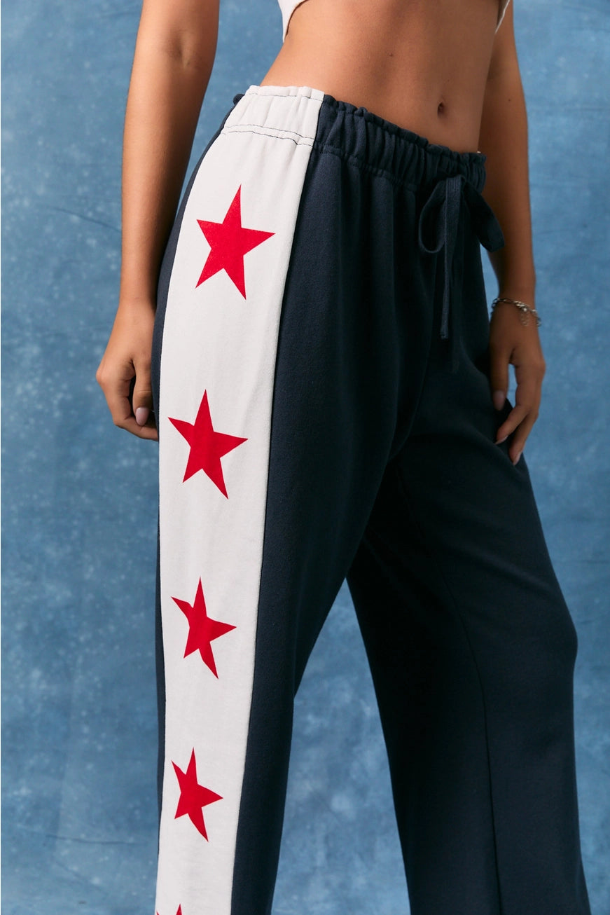 Le Lis star side stripe wide leg baggy sweatpants with relaxed fit and bold star accents, casual and comfortable for everyday wear.
