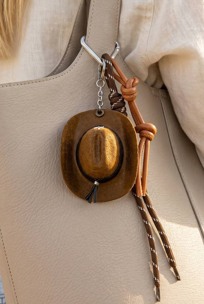 Mini cowboy hat Western rope bag charm with braided details, perfect as a stylish accessory for bags or keychains.