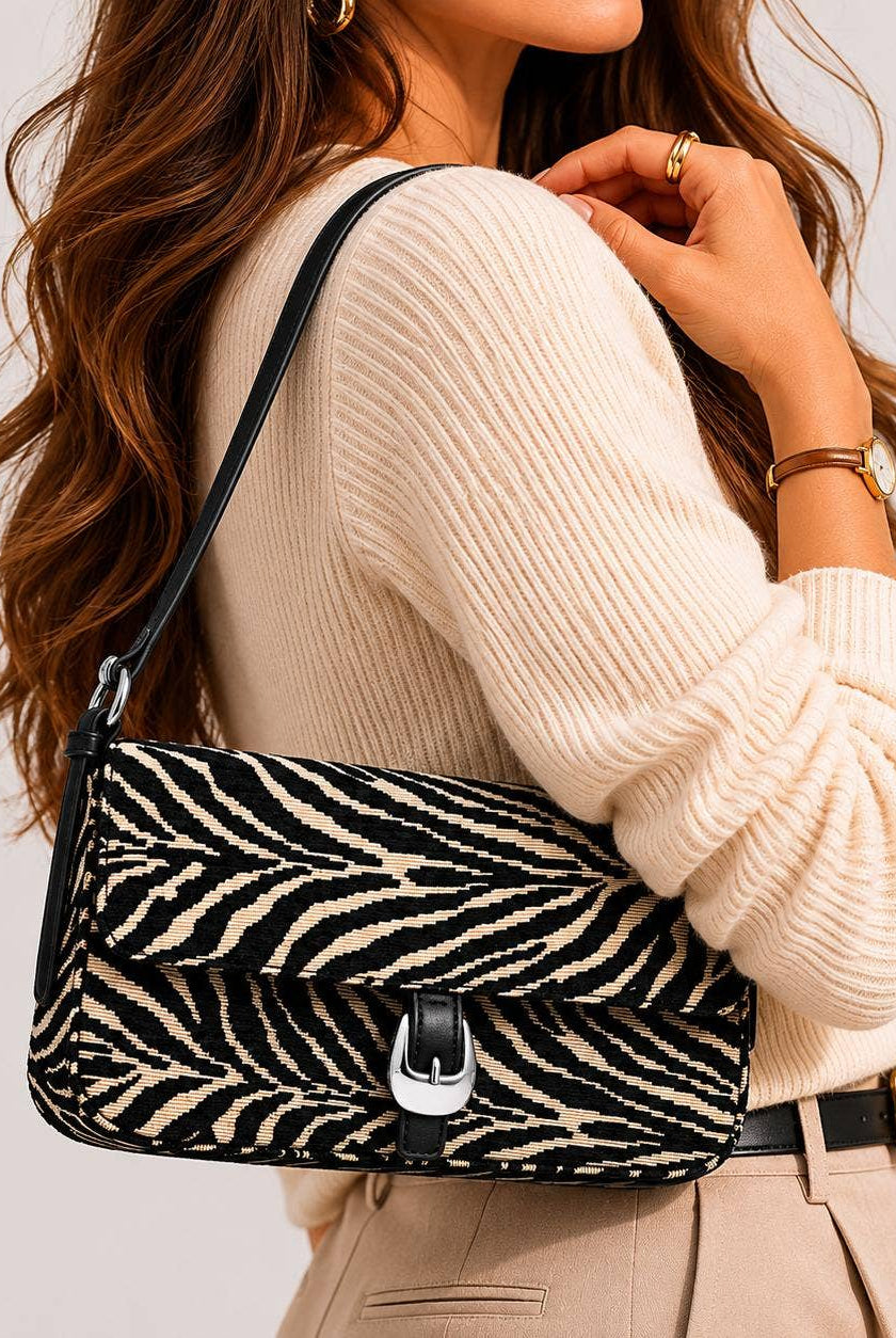 Urban Expressions Tuesday Gloria zebra shoulder bag with adjustable strap and stylish black and white zebra print fabric.