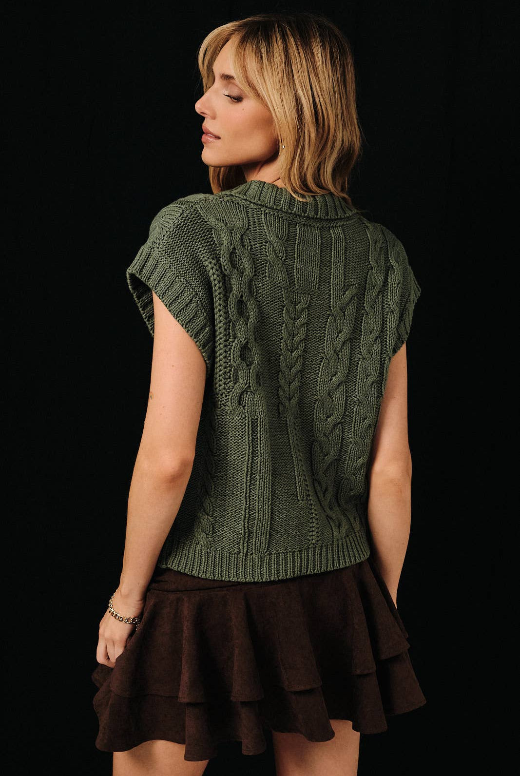 Cable knit button-up sweater vest by Sunday Edition, featuring a classic cable knit pattern and button details in natural tones.