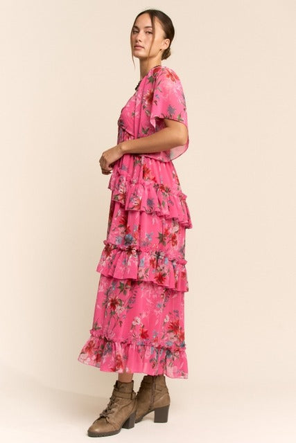 Floral tiered ruffle maxi dress with flutter sleeves from RARA Boutique, featuring a flowing design and vibrant floral pattern.