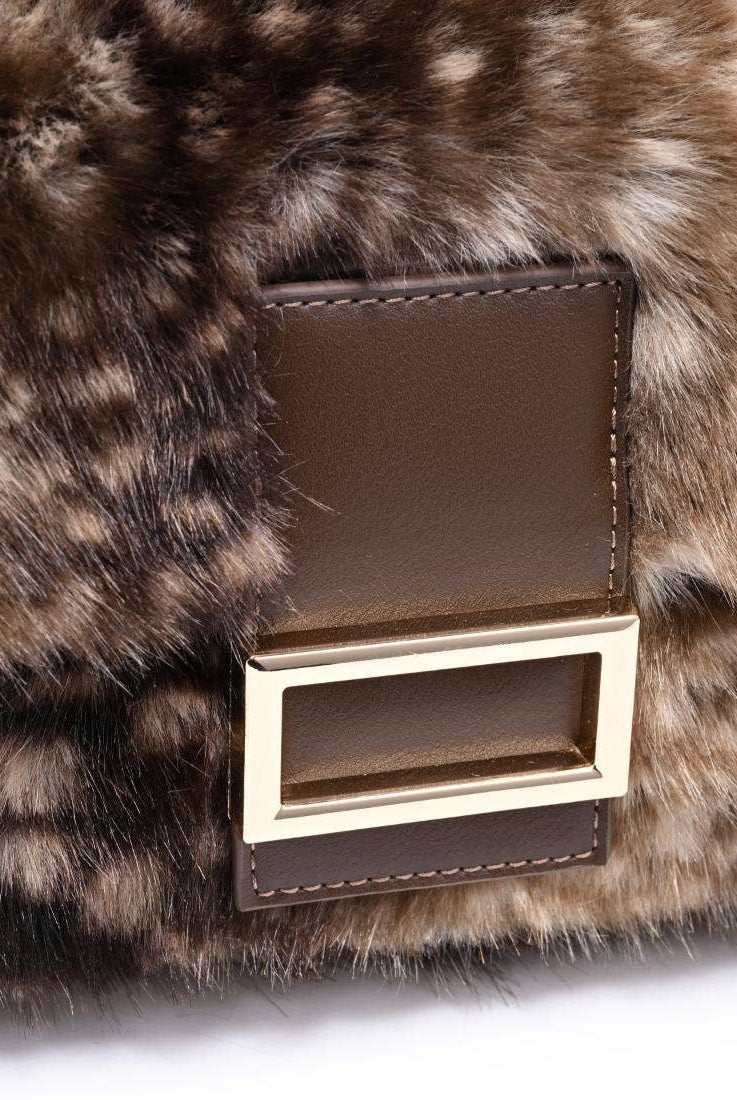Urban Expressions Tuesday Beverly deer print fur crossbody bag with adjustable strap and zippered closure.