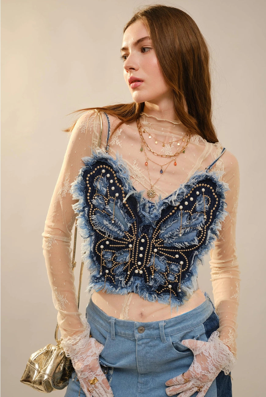 Blue RARA Boutique denim corset top with butterfly embellishments, styled as a fashionable blouse with decorative details.