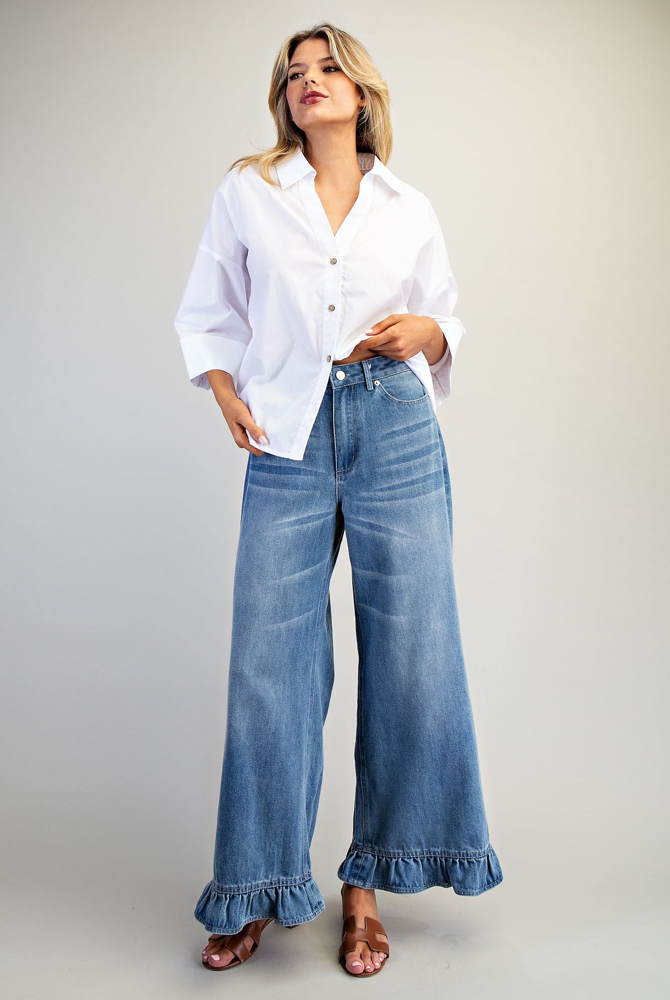 Ruffle hem wide-leg mineral washed jeans from RARA Boutique, featuring a relaxed fit and stylish ruffle details.